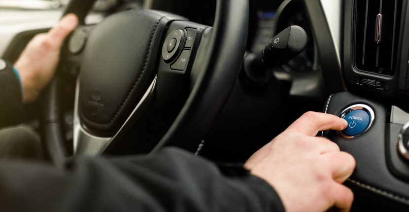 Person pushing a push start button