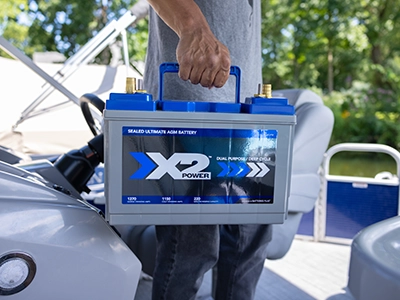 Person carrying an X2Power AGM boat battery
