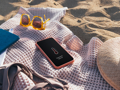 Phone laying out on a towel on the beach