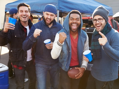 Group of people in sweaters and jackets tailgating