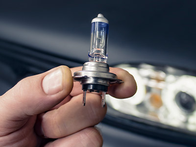 Holding a replacement car headlight