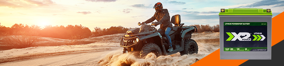 A person driving an ATV in sand, Lithium battery hero